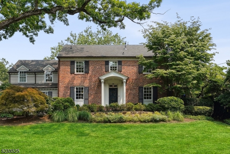 Architectural details and craftsmanship are evident everywhere. Renovated and expanded 5 Bedroom (all en-suite) + 2 Half Bathrooms custom colonial in the heart of Old Short Hills located in the coveted Knollwood section - a few blocks to Short Hills midtown direct station. Spread across 4 levels, recent upgrades and renovations include: Kitchen expansion, renovated bathrooms, new Mudroom, 2nd floor laundry room, updated gas fireplaces, extensive hardscaping and landscaping, newer Pella windows + newer HVAC system. Covered entry leads to Foyer with 2 closets. Living Room with new gas fireplace enjoys access to Sunroom / Office with wraparound windows and patio access. Dining Room leads to Kitchen and Family Room. Eat-in Kitchen features honed granite countertops, high-end stainless steel appliances + large island with seating for 4, wine refrigerator, storage, new walk-in pantry. Breakfast area has access to new patio and level yard. Open concept Family Room with new gas fireplace. New Mudroom connects to 2-car garage. Powder Room completes sprawling 1st level. Open staircase leads to 2nd level featuring 4 bedrooms (all en-suite + renovated). Primary Bedroom retreat with 2 walk-in closets and Bathroom with glass-enclosed shower, soaking tub + dual sink vanity. Newer Laundry Room + study area round out 2nd floor. 3rd level provides a 5th en-suite Bedroom + Media Room and Workspace. Lower Level boasts a Rec Room, Home Gym / Music Room, Storage + Powder Room.