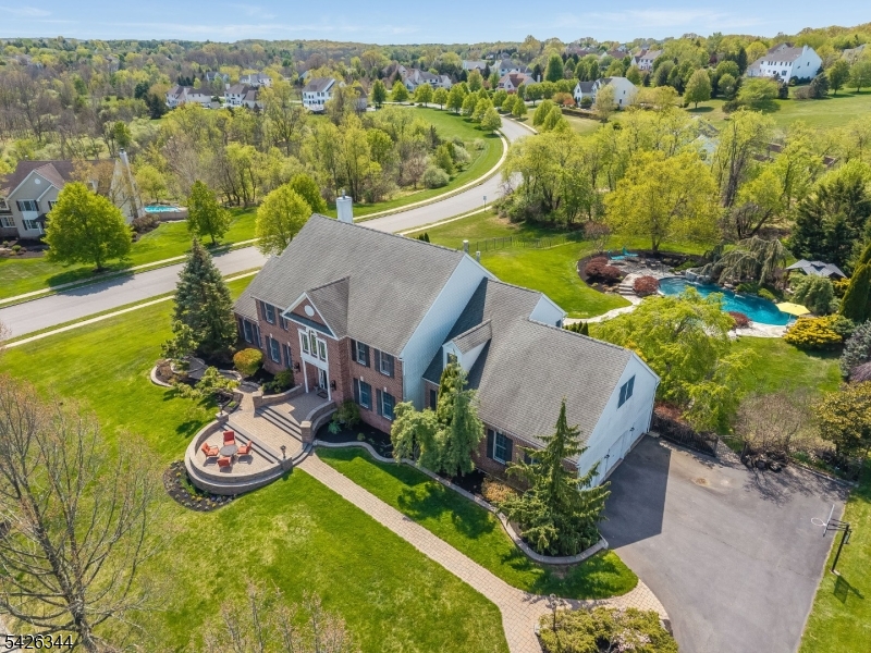 6,678 sq ft including an expansive finished basement with bath. This stately colonial offers 4/5 bedrooms & 6 baths including private1st floor potential guest suite with full bath. The  property delivers extraordinary space with a floor plan that flows effortlessly from room to room. A grand foyer opens to the living & dining rooms, conservatory, family room, morning room, kitchen, & powder room. This connected, open layout  lives beautifully at every scale. Completing the main level is a private wing featuring a stunning office with custom bookshelves and dry bar, plus a full bath; perfect as a self-contained guest suite. Upstairs, the primary suite impresses starting with a spacious bedroom with tray ceiling, a sitting room with three-sided fireplace, a second bonus room ideal for a home office or gym, two large closet and an ensuite bath. Three additional bedrooms each enjoy private bath access and generous closet space.The finished basement delivers 1,820 SQ FT of versatile living with a large rec room, bar with beverage cooler, sink, and private wine room, media room with theater seating, home gym, and a cozy den with fresh air ventilation, stacked stone gas fireplace and wall sconces. Outside, a custom heated saltwater pool with two waterfalls, zero-edge design, integrated hot tub, gazebo, and a large multi-level paver patio, all wrapped in mature privacy landscaping offering a true backyard escape. SQ FT per tax records. two new HVAC units approx 1-4 yrs old.