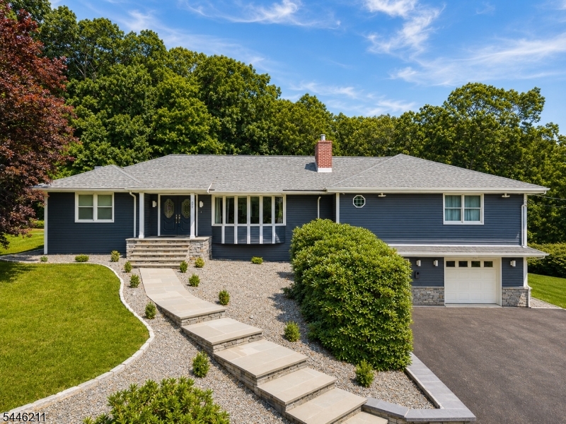 Exceptional oversized ranch offering luxury, space, and endless possibilities, including a potential in-law suite. This beautifully maintained home offers 4 bedrooms, a private office, and 3 full bathrooms. The heart of the home is the stunning open-concept kitchen overlooking the living and family rooms, featuring an impressive 11' x 12' waterfall island with cabinetry on both sides, quartz countertops, stainless steel appliances, a hands-free range hood, and surround sound. The spacious living area contains hardwood floors and a beautiful stacked marble fireplace. Retreat to the luxurious primary suite featuring a walk-in closet and oversized spa-like shower. The finished lower level offers exceptional flexibility with a second kitchen, full dry bar, spacious recreation area, and is ideal for extended living. Additional highlights include 8-zone heating, high-efficiency Rheem AC, smart 80-gallon water heater and whole house UV water filtration system.Car enthusiasts will love the oversized 4-car garage, circular driveway with parking for 8+ vehicles.  Enjoy the backyard retreat with a heated pool, gazebo with electric and ceiling fan, expansive 30' x 50' paver patio, and new retaining walls and walkways. Stacked stone exterior, bluestone entry, new siding, gutters, fascia, and fresh landscaping complete this remarkable home. Backing to Minnisink County Park and just minutes away from Hopatcong Lake, offering year-round outdoor recreation. This house is a must see!