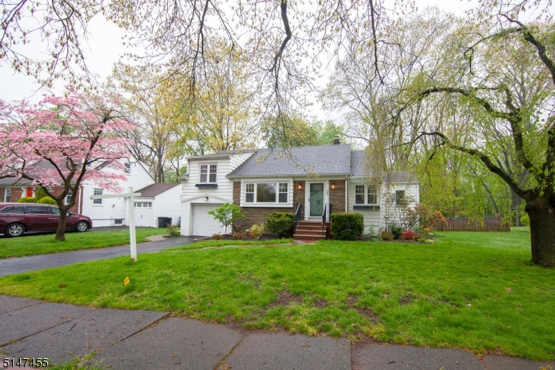 Welcome home...You will love this spacious Cape Cod colonial in a beloved GR neighborhood known for its two cul-de-sacs and oversized backyards! Step inside and you will be drawn to the oversized "Great Room" with a burning fireplace. Two full bathrooms - including a master! - Accompany 3 nicely sized bedrooms with plenty of light. Full size attic plus an attached garage with a great mudroom area for storage. Finished basement with laundry room is an ideal rec room or guest space. Fenced-in backyard features a patio for entertaining and backs up to parkland - plenty of green space! Recent updates: Central Air (3 yrs), furnace (1 yr), s/s range & dishwasher (2 yrs). Top-rated schools, one block from the jitney to the NYC train!