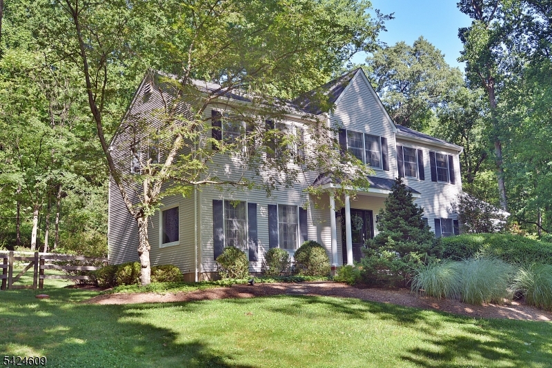 Located in desirable Hunterdon County (just past Clinton) - Discover the perfect blend of privacy, space, and comfort in this beautifully updated Colonial, tucked away at the end of a quiet cul-de-sac in sought-after Hickory Ridge. Surrounded by scenic year-round views, this home offers a peaceful setting with exceptional convenience.A welcoming foyer leads to elegant formal living and dining rooms and a stunning renovated eat-in kitchen designed for both everyday living and entertaining. Features include custom cabinetry, a built-in refrigerator/freezer, and newer high-end SS appliances. Sliding doors open to a spacious deck, while the breakfast area flows into the large family room with a FP. The main level also includes a private den, a PDR, and a laundry area. Upstairs, the MBR suite offers a walk-in closet and an updated bath, along with three generously sized bedrooms, a refreshed hall bath, and pull-down attic access. The finished lower level offers exceptional versatility, with a recreation room, a wet bar with a new refrigerator, a dedicated gym, a mudroom, a utility/storage room, and direct access to the garage. Outside, enjoy a large, level, fenced backyard designed for relaxation and entertaining, featuring an oversized deck with a retractable awning, a storage shed, and an additional seating area. Recent updates include a newer roof and low-maintenance vinyl siding. Top-rated Hunterdon schools, close shopping and dining, just off I-78 Exit 12.