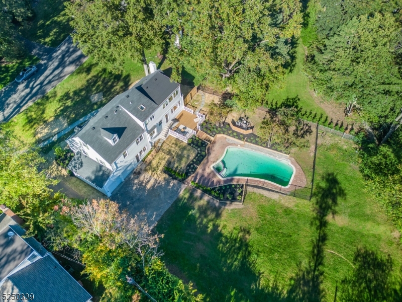 STUNNING COMPLETELY RENOVATED 6-BEDROOM COLONIAL ON HUGE LOT W/OUTDOOR POOL IN UPPER MONTCLAIR-CLOSE TO NYC DIRECT TRAIN.  Gorgeously curated state of the art kitchen w/streamlined look has Bertazzoni 6-burner stove, Bertazzoni double-doored fridge w/custom white cabinet paneling, Bosch dishwasher w/custom white paneling, huge white quartz center island topped w/white pendant lighting  & gold accents, plenty of cabinetry w/gold hardware incl pantry & tons of windows-bringing the outdoors inside!  Loads of sunlight  & what a view! Approx 1/2 acre flat bkyrd w/pool & plenty of space for entertainment or dinner on the deck.  Showpiece living room has floor to ceiling built-ins & wood-burning fireplace. 2nd flr boasts four nice-sized bedrooms + newly renovated main bath.  Gracious, sunfilled generous primary bdrm on 3rd lvl includes skylight, sitting area w/a wall of windows overlooking bkyrd & pool.  Primary bath is instagram-ready!  SO CHIC!  Freestanding egg-shaped soaking tub, double sinks, skylight, glass-doored shower, elegant floor tiles & fixtures. Not done! Lwr level is perfect fam rm for watching your favorite Netflix movies + there's a convenient full bath attached.  MORE room in fully fin bsmt...can be playroom, pool room, guest room, endless possibilities.  Gas heat, AC, HW flrs, 2-car garage. Enjoy 3 parks all less than a 1/2 mile away...where you will find playgrounds, dog parks, rose gardens, running & walking trails & in the summer, fireworks & outdoor concerts.