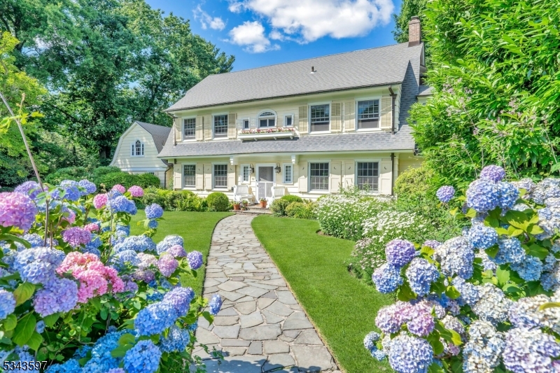 You'll be enchanted- like most everyone else in Montclair- by this Nantucket-like retreat in the town's most sought-after neighborhood: Erwin Park. A delightful blend of original charm and open, airy spaces, this home exudes relaxed elegance. Ideally located just 3 blocks from the NYC Midtown Direct train, Watchung Plaza shops, and every level of school. From the moment you pass through the white picket fence and garden gate, you'll be captivated. A grand floating staircase greets you, leading to light-filled living & dining rooms, perfect for entertaining. The oak-paneled family room is cozy for movie nights or quiet reading by the fire. The glamorous sunroom with its hand-stenciled floor offers a front row to the backyard splendor .The updated chef's kitchen with center island, breakfast  room & pantry is spacious and cheery. A new custom laundry/mudroom adds convenience. Enjoy the high-ceilinged rec room-perfect for play, WFH or exercise. The serene primary suite boasts a renovated bath and spacious dressing room w/ original built-ins. Two generous en-suite bedrooms and a beautifully designed office complete the picture. The bright 3rd fl features 3 more bedrooms, full bath & loads of storage. The fenced backyard is a private oasis with a heated gunite saltwater pool, sprawling lawn, stunning landscaping, vegetable beds, flowers galore, & a charming treehouse! An expansive bluestone patio & veranda are perfect for al fresco dining.16 Erwin Park is a true gem. Welcome home!