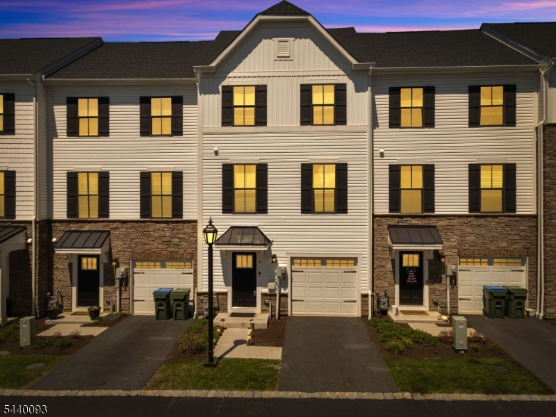 Enjoy modern living and everyday convenience in this newer construction interior-unit townhome built in 2024. Offering nearly 2,000 sq ft across three beautifully finished levels, this 3-bedroom, 2 full bath, 1 half bath home is thoughtfully designed for today's lifestyle. The entry level features a versatile flex space ideal for a home office, gym, media room, or playroom, along with direct access to a private patio perfect for relaxing or entertaining outdoors. Upstairs, the sun-filled main level showcases an open-concept layout with seamless flow between the living and dining areas. The designer kitchen features quartz countertops, stainless steel appliances, and a large center island with breakfast bar seating. Step outside to your private deck for easy indoor-outdoor living, while a convenient powder room completes this level. The top floor offers three spacious bedrooms, including a serene primary suite with tray ceiling, walk-in closet, and spa-inspired en-suite bath. Two additional bedrooms, a full hall bath, linen storage, and in-unit laundry provide both comfort and functionality.Ideally located near dining, shopping, outdoor recreation, the Hackettstown Train Station, and Routes 46 & 80 for an easy commute. Enjoy all that Hackettstown has to offer with its charming, walkable downtown filled with local restaurants, cafes, shops, and community events.