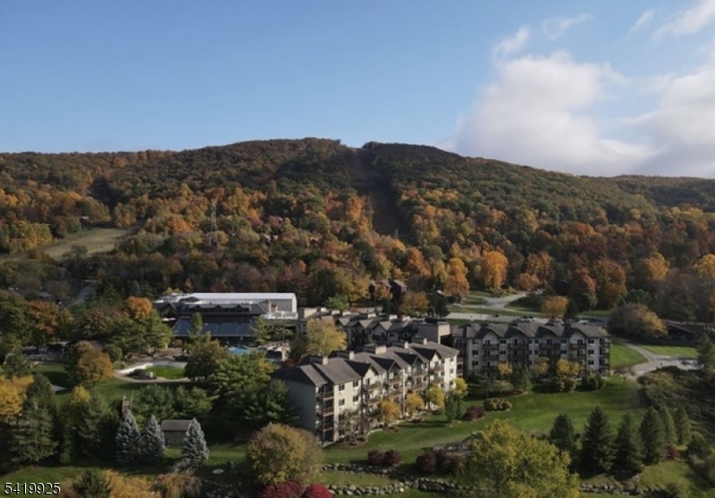 Fully furnished Condo/Hotel Unit at The Minerals Hotel and Spa! 50 miles from NYC. Don't miss this spacious luxury junior suite located on the same level as the lobby and gym. Step through a full-sized glass door onto your private balcony with scenic views overlooking mountains and property's great lawn. Enjoy full access to the resort's premier amenities, including indoor and outdoor pools, a state-of-the-art fitness center, luxurious spa, and game room. Just minutes from world-class golf courses, ski slopes, mountain bike trail, waterpark, restaurants and all the natural beauty Sussex County has to offer. This unit is perfect as a personal vacation retreat and when you're not using it, generate passive income through the hotel's rental program. Additional highlights include a gas fireplace for all year long cozy ambulance. While there's no full kitchen, the unit features a convenient breakfast bar with a sink, small refrigerator, microwave, and coffee/tea setup. A rare opportunity to own in one of the area's most sought-after resort communities!