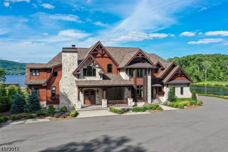 This majestic, custom built lakefront paradise sits on over 8 acres of breath taking property with 300ft lake frontage on the highly desirable Culver Lake. Upon entry you'll be greeted by an open concept living space and soaring ceilings offering modern amenities and endless luxuries. 1st floor master/w lake and mountain views. Great Room with Dual fireplace. Gourmet kitchen with enormous center island. over 8,000sf living space. 2nd floor game room/w bar. custom wood work and hard wood floors throughout . dock, private peach ,basketball/tennis/volley ball and Bocce courts. additional garage for Canoe's etc.