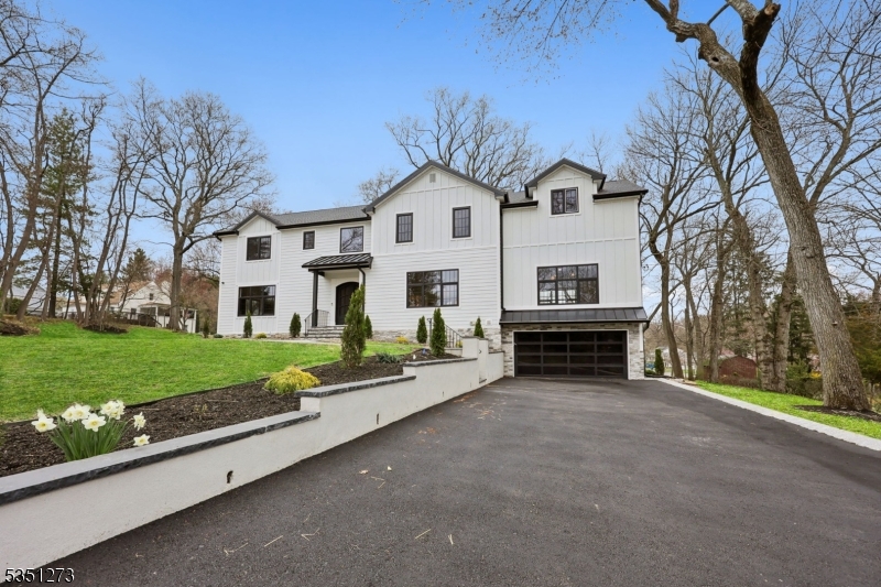 Nestled on a sprawling lot in idyllic Wyckoff, welcome to this 2025 custom designed & masterfully crafted 6-bed 5.1-bath residence where timeless elegance meets cutting-edge smart home innovation. Step into a stunning 2-story foyer, where wide-plank hardwood floors & custom millwork lead you through arched entryways to the heart of the home. The showcase kitchen stuns w SS appliances, premium cabinetry, quartz backsplash & 12ft center island w waterfall quartz counters & breakfast bar. Dine in style in the formal dining room adorned w herringbone hardwood floors or the sunlit dinette w wet bar, built-in seating & walk-in pantry. The formal living room features a fireplace w built-in cabinetry, while the family room showcases a wood-accent wall & second fireplace. The luxury primary suite is a sanctuary w vaulted ceilings, dual WICs & spa-like ensuite bath w free-standing tub, double vanity & walk-in shower. The 1st floor ensuite bedroom adds flexibility, while 3 additional 2nd floor bedrooms w ensuites/WICs provide privacy for all. The large finished basement offers an additional bedroom w full bath & egress. Featuring future-ready tech, this smart home includes pre-wired smart outlets, immersive audio system, pre-wired security system & touchscreen control center. Outside, the exterior impresses w stone-accented foundation & rear deck overlooking the spacious backyard. Experience this custom build, perfectly blending luxury, comfort, and smart living in a prime location!