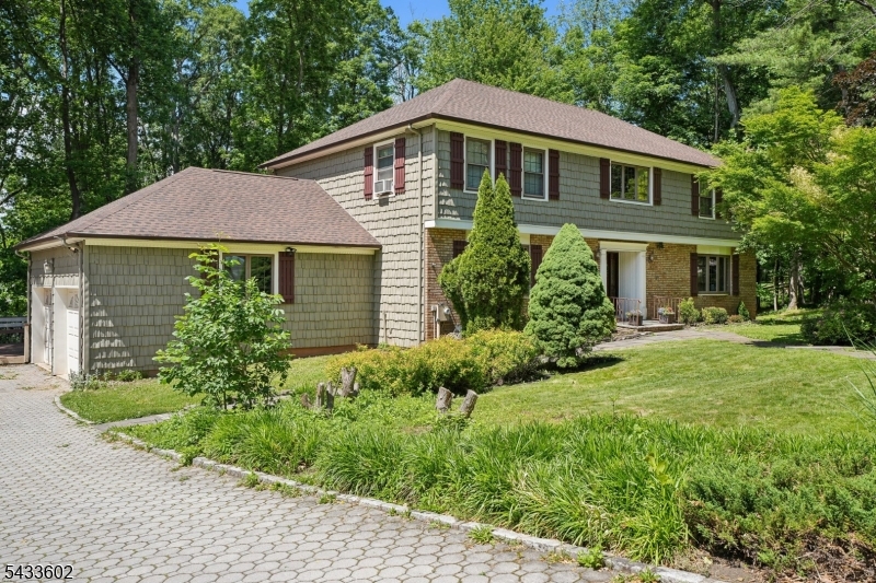 Set on a private 0.81-acre lot, this refreshed Center Hall Colonial offers an exceptional opportunity to personalize and enhance over 4,600 square feet of versatile living space designed for comfortable everyday living and effortless entertaining. A welcoming foyer opens to sunlit Living and Dining Rooms, both highlighted by elegant bay windows. The spacious Family Room features a wood-burning fireplace with stone hearth and flows into a screened Porch with direct access to the expansive two-tier deck and deep backyard ideal for indoor-outdoor gatherings. The eat-in Kitchen is thoughtfully appointed with wood cabinetry, Corian countertops, center island, stainless steel appliances, and a separate Breakfast Area with deck access. A Powder Room, Laundry Room, and entry to the attached two-car Garage complete the main level. Upstairs, the Primary Suite offers a walk-in closet and private full Bath. Three additional Bedrooms, each with walk-in closets, share a full Hall Bath. The finished Lower Level provides outstanding flexibility with a Recreation Room, Office, Music Studio, Exercise Room, full Bath, and abundant storage. The expansive backyard and multi-level deck create the perfect setting for entertaining, recreation, or quiet relaxation. Recent improvements include a new roof. Located in a highly rated school district and close to shopping, dining, and parks, with approximately 1.3 miles to the Berkeley Heights Midtown Direct train to NYC Penn Station.
