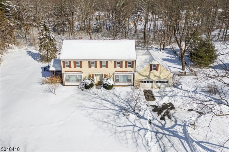 Beautiful, charming, large 5 BR, 2.5 BA Mendham Boro Colonial w/ pool. 5 spacious bedrooms w/large closets. Spacious/gracious LR & DR w/ over-sized windows providing bright light.Sunny eat-in kitchen, cozy family rm features a FP & walkout porch. HW Floors. Laundry rm & pantry off kitch w/walkout to beautiful backyard w/stunning pool. In the heart of Mendham on a quiet cul-de-sac. Put your personal touch on LL which has potential for a family rm, game rm, exercise area & storage. LL has walkout to backyard. Short walk to local Main Street shopping, grocery store, restaurants, schools, parks, Patriot's Path & convenience mall. Enjoy scenic walks in the woods at your leisure. Close to Mendham Borough Park, Gazebo, tennis, basketball, baseball fields. Full attic storage. May finish garage loft. Dead end st.