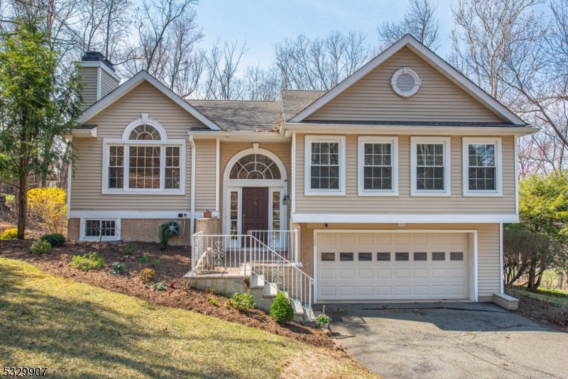 Welcome to this beautiful 3-bedroom, 2.5-bathroom bi-level home, located on a Cul-de-Sac in the highly regarded, gated, Panther Valley Community. The main floor showcases elegant herringbone hardwood floors that flow seamlessly through the open living and dining areas. The living room features soaring high ceilings, a cozy fireplace, and an abundance of natural light streaming through large windows. Sliders from both the dining room and kitchen lead to a deck with a large electric awning, perfect for outdoor dining and entertaining.The primary suite offers a private retreat with a generous walk-in closet and an en-suite bathroom featuring both a stall shower and a tub shower for ultimate relaxation. Two additional bedrooms and a full bathroom complete the main level. Downstairs, the finished lower level provides a versatile family room with sliders leading out to a patio, perfect for indoor-outdoor living. A convenient half bath, laundry area, and access to the attached 2-car garage complete this level.With thoughtful design choices, abundant natural light, and fantastic views off the deck, this home is ready for you to make it your own. A short distance from one of the 3 pools located in the Panther Valley community, perfect for hot days. Don't miss this exceptional property, schedule your tour today!
