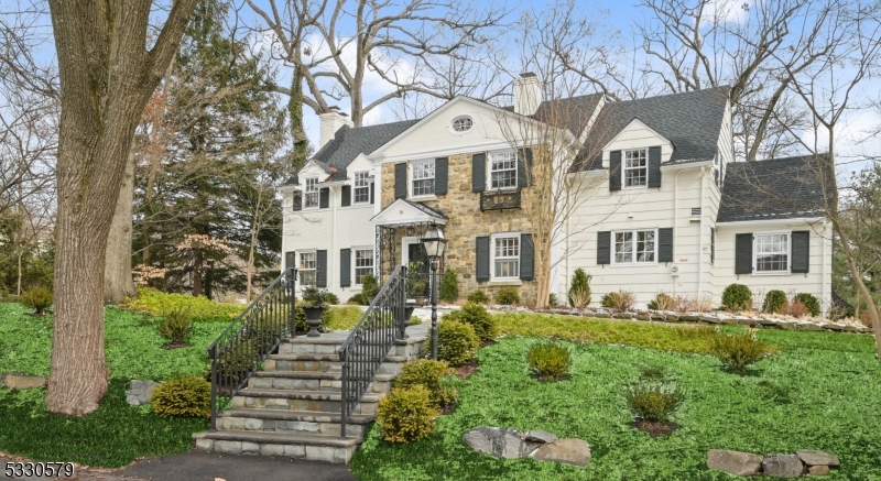 You are invited to step into timeless elegance with this charming updated 1930s Colonial nestled in the heart of Old Short Hills This home features a Canterbury kitchen  with top of the line appliances, custom cabinetry, quartz counters, Wolfe range ,Sub zero fridge and a Miele dishwasher that is perfect for entertaining. Classic architectural details, such as hardwood floors, crown molding, and spacious rooms add to the appeal. Situated on a generous lot, the professionally landscaped property offers both privacy and convenience, just minutes from top rated schools, shopping, and the train to NYC. Don't miss the opportunity to make this classic beauty your own