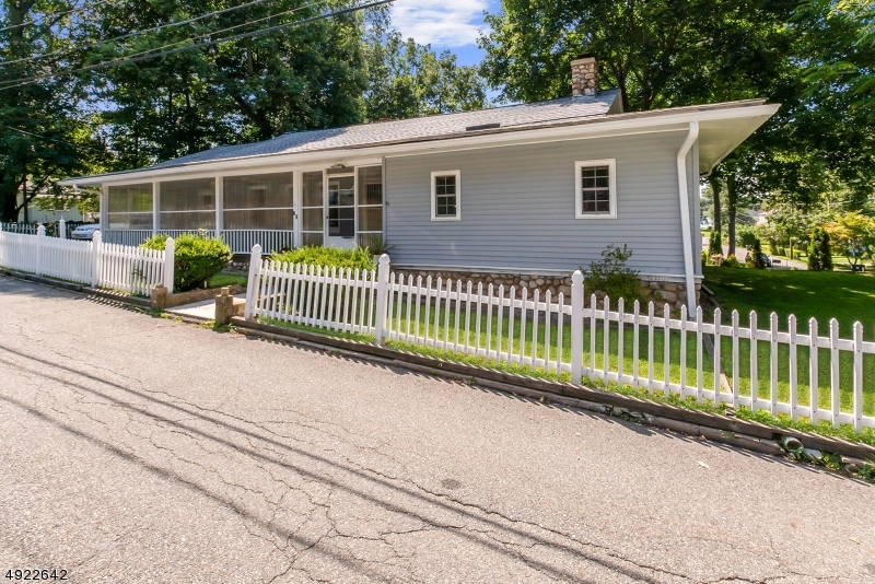 Fabulous lake-style ranch in Budd Lake section of Mt. Olive.  Lots of character & charm.  Wood burning stone & brick fireplace in living room with beamed ceiling, large eat-in kitchen, family room, office, three bedrooms, main bath, and mud room make up the first floor.  There is a wonderful enclosed porch at the front off the house.  Upstairs there is a loft, bedroom and storage room.  There is a fenced yard and detached 1 car garage.  Walk to Budd Lake, wonderful neighborhood, close to highways, schools, restaurants & shopping.  Don't miss this wonderful opportunity to live by the lake.