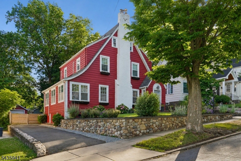 Welcome Home to this beautifully renovated English Colonial, nestled on one of Maplewood's most beloved streets. Freshly painted and polished to perfection, this home is truly move-in ready! Gleaming hardwood floors flow through a warm and welcoming Living Room with a wood-burning fireplace, and a Formal Dining Room with French doors that open to a sun-filled 'Maplewood Room'   perfect for everyday living and effortless entertaining. The Kitchen features granite counters, custom cabinetry, and stainless appliances, with easy access to gorgeous backyard. Upstairs, the second floor offers three bedrooms and a stunning full bath adorned with Carrara marble and a custom handmade vanity with 2 washbasins. The third floor is a true bonus-  a versatile playroom/bedroom retreat with skylights and plenty of storage. The finished basement adds even more living space, complete with a  rec room, second Carrara marble full bath, fitness area, laundry room, storage and utilities. Step outside to a fabulous outdoor haven- a beautiful paver patio and manicured backyard complete with a custom-designed outstanding outdoor play space that conveys with the home. Whether you're hosting or simply unwinding, this backyard delivers!  Additional highlights include five split AC units,  fab front walkway and retaining wall.  With the NYC jitney right at the corner, commuting couldn't be easier.