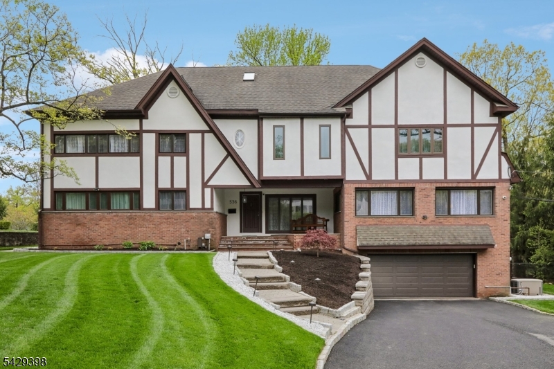 Step into timeless elegance with this beautifully updated Colonial/Tudor-style home in sought-after Englewood. Blending classic charm with modern comforts, this 4-bedroom, 3 full bathroom residence is truly move-in ready and designed for both everyday living and effortless entertaining.The heart of the home features a stunning sunken living room, complete with a cozy gas fireplace and custom built-ins an inviting space filled with warmth and character. The thoughtfully updated interior flows seamlessly, offering spacious rooms, abundant natural light, and large walk-in closets that provide exceptional storage throughout.The finished basement expands your living space with a stylish bar area, perfect for hosting gatherings or unwinding at the end of the day. Convenience is key with laundry rooms located both in the basement and on the bedroom level.Step outside to your private backyard retreat, where a large patio, professional landscaping, and ambient outdoor lighting create the perfect setting for relaxing evenings or entertaining under the stars. A generous grass yard offers plenty of room for recreation and play.Additional features include a security system for peace of mind, whole-house generator and recent updates that ensure a turnkey experience for the next homeowner.A rare blend of character, comfort, and modern upgrades this is the home you've been waiting for.