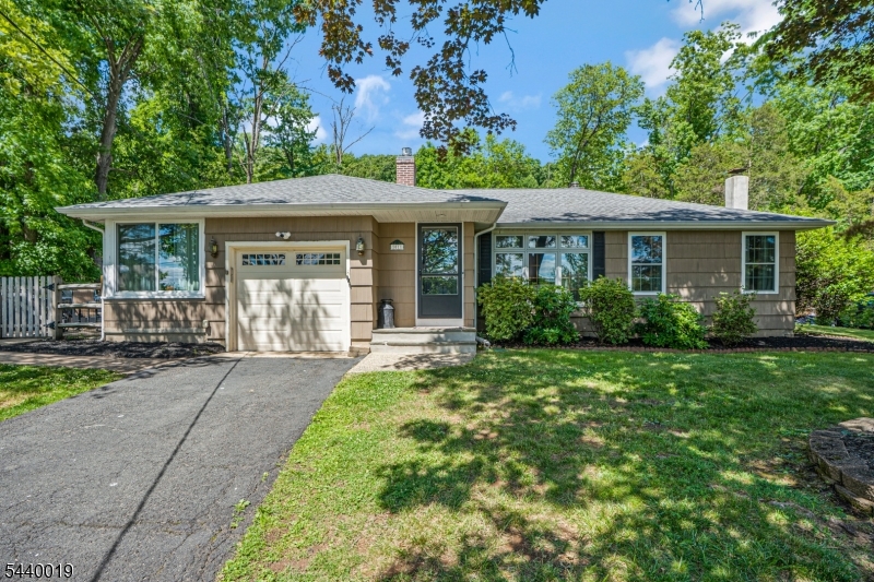 Turn-key ranch-style living in highly desirable Bridgewater, with optional membership to the Sunset Lake community! This beautifully updated 3-bedroom, 1.5-bath home offers the convenience of one-floor living and is truly move-in ready. Step inside to a bright and inviting living room featuring gleaming hardwood floors, custom millwork, a gas fireplace, and large windows that fill the space with natural light. The floor plan flows seamlessly into the dining area and updated kitchen, complete with SS appliances, abundant cabinetry, and generous counter space. Just off the kitchen, enjoy year-round entertaining in the newly renovated enclosed porch, or step outside to the spacious patio overlooking a private backyard featuring a retaining wall, fire pit area, and newly planted trees. The three bedrooms offer flexibility for a home office, guest room, or playroom. The finished LL expands the living space with a recreation room, new flooring, ample storage. Recent updates include a hot water heater ('22), New AC Unit ('25), updated main bath ('26), a SpringWell saltwater water filtration system, new windows in the primary bedroom and sunroom.. Additional highlights include an attached one-car garage and ample driveway parking. Conveniently located near top-rated schools, shopping, dining, parks, and major highways, this exceptional home offers the perfect blend of comfort, style, and convenience.  Just unpack and enjoy!