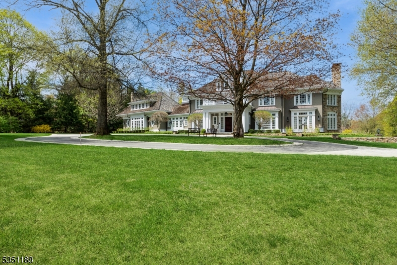 Surrounded by nature, this 22-room custom built estate with 5 bedrooms, 6 full and 4 half baths is a welcoming oasis. From first glimpse, a discerning buyer will be impressed with the architectural features and attention to detail in this elegant home.  This magnificent estate boasts a gracious foyer with curved staircase, copious custom millwork and cabinetry, French doors, and beautiful windows with transoms. A stunning main suite with sitting and dressing rooms, walk-in closet, handsome great room with bar, three fireplaces, and superb kitchen with 2 islands are some of the many outstanding quality features. A mirrored workout area on the third level and walk-out lower level with game room, recreation room, baths and 2 wine cellars are added amenities. While relaxing on the spacious stone terrace, enjoy the views of the beautiful perennial gardens, freeform pool and spa. A 4-car finished garage with custom built-ins and amazing detailed woodwork completes this 4.98-acre private estate. Take advantage of this rare opportunity to live in luxury in this highly sought after location. Peter Dorne, Architect and builder for expansions and renovations.