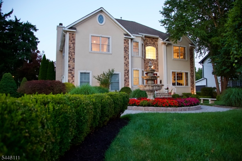 Luxury abounds in this meticulously maintained custom built home where exceptional craftsmanship and timeless elegance come together in a breathtaking setting. A welcoming fountain, beautifully manicured gardens and elegant paver walkways create an inviting first impression. This stunning residence features 4 spacious bedrooms and 3 1/2 luxurious bathrooms thoughtfully designed for both comfort and sophistication. The gourmet kitchen features granite countertops, upscale stainless-steel appliances and overlooks the inviting family room with a cozy gas fireplace perfect for everyday living and entertaining. Sliding glass doors lead to a spectacular outdoor oasis featuring a paver patio, gazebo, grilling area and exquisitely landscaped gardens that offer a private paradise- like retreat. The generously sized bedrooms provide ample space for guests. The luxurious primary suite serves as a true sanctuary complete with a spa inspired bath featuring a jetted soaking tub. separate shower and custom built in cabinetry. A conveniently located 2nd floor laundry room adds to everyday ease. The expansive finished basement offers endless possibilities for recreation, fitness or entertaining showcasing hardwood flooring, a mirrored wall- ideal for a home gym or studio and a full bathroom for added convenience. This exceptional home combines luxury comfort and impeccable attention to detail creating an extraordinary lifestyle both inside and out.