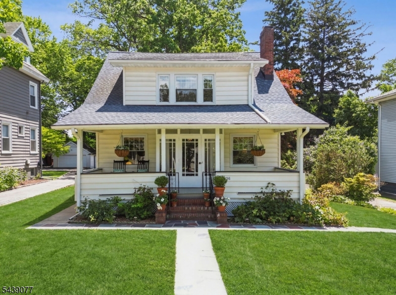 Located on a tree-lined street in the heart of South Orange, this charming home blends classic details with modern updates. Ideal for both everyday living and entertaining, it offers spacious, sun-filled rooms, coffered ceilings and hardwood floors throughout. A welcoming front porch provides the perfect place to relax and enjoy the neighborhood. Inside, an entry vestibule opens to a gracious living room featuring a wood-burning fireplace. The sunlit dining room is accented by wainscoting and opens to a deck overlooking the expansive backyard surrounded by mature landscaping. The well-appointed kitchen is equipped with stainless steel appliances, butcher block countertops, a custom banquette breakfast nook and a pantry for added convenience. Upstairs, there are three well-proportioned bedrooms with generous walk-in closet space including custom built-in cabinetry, and a full bath. The finished lower level provides additional living space with a large rec room, another full bath, storage space and a laundry area. A detached garage and shed add further storage. Ideally situated just moments from restaurants, shopping, parks and commuter trains to NYC, this home is the perfect blend of suburban charm and urban accessibility.