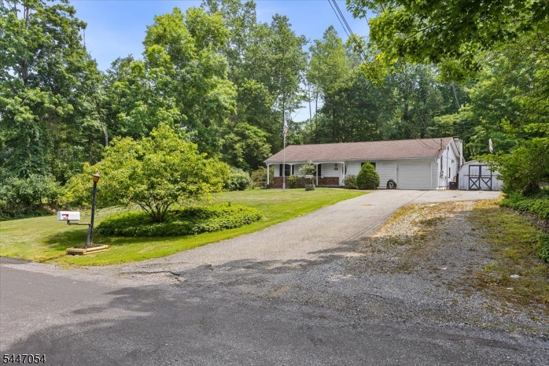 Easy one floor living in this expanded Ranch situated on nearly 3/4 acres with plenty of parking for vehicles and/or RV/Boat/etc. NEW septic in process of being installed! Newer roof! Large country Kitchen with ample counter space and cabinetry. A custom handcrafted mantle and surround with built-ins flank the fireplace in the Living Room. The main living area is flooded with natural light that flows in through the sliders that lead to a ground level patio. The fenced in backyard is the perfect spot for outdoor entertaining with the built-in BBQ, patio and pergola. Back indoors you'll find 3 bedrooms including a Primary with direct access to the backyard and a private ensuite. Hardwood floors throughout. Central Air! Paulinskil Lake Association offers multiple, Member Only beaches, Tennis/Basketball courts, picnic area as well as many community actives. Fishing, boating, kayaking...create YOUR lake life! Weather you're just starting out, downsizing or anything in-between,  this home has plenty of space and a great yard!