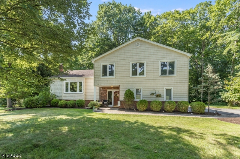 Pride in homeownership in this beautiful 4 bedroom, 2.5 bath Split Level with attached 2 car garage in a quiet Cul-de-sac! Walk the newer paver walkway to the front door. Enter into a welcoming foyer that opens to a sun-drenched living room & dining room with newer windows throughout and gleaming hardwood floors. Kitchen has been upgraded with stainless steel appliances and has great natural light through slider door to deck Spacious new deck (2020) with natural gas line for BBQ and large, park-like level backyard are great for entertaining.  Large family room anchored with stone around wood burning fireplace & sliders leading out to paver patio.  Laundry & powder room conveniently located on ground floor finish out this level.  Second floor features hardwood floors down hallway, large master en suite with closet, 3 additional spacious bedrooms & hall bath. The basement is a large space currently used for utilities and storage yet has endless possibilities.  Home sits on over 1/2 of an acre with mature landscaping. Home also features gutter guards, whole house attic fan, natural gas, public water, and public sewer. Located in the Succasunna section of Roxbury Twp. with close proximity to Rt 10, Rt 46, Rt 206 and Rt 80, train in Mount Arlington or Netcong, shopping, dining and highly rated schools. Welcome home!