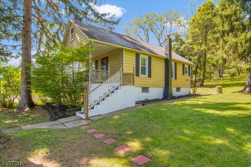 Please present your best terms and highest offer by 5pm on May 27th. Looking for a cozy alternative to condo living without the HOA fees? This charming and serene Cape Cod sits on nearly 1.4 acres and offers the perfect starter home opportunity. Featuring One bedroom and 1 full bath with an additional room w/closet that can be used as a guest bedroom, this well-maintained home is neat as a pin and move-in ready for its next owner. The upstairs attic provides valuable bonus space that can be used as an additional room, office, or finished storage area. Interior features include beautiful hardwood floors throughout, two split A/C units for added comfort during warmer months, forced-air heating, 2 stage whole house filtration systems, plus an additional reverse osmosis filter in the kitchen. The home also includes a newer well water tank for added efficiency. Enjoy peaceful mornings on the covered front porch or relax on the backyard patio during lazy summer afternoons sipping tea while taking in the beautiful views. Thoughtful exterior improvements include French drains installed for added peace of mind during heavy rains. Additional updates are a brand-new electric cooktop stove and front storm door. The basement houses utilities and offers ample additional storage space.Enjoy privacy, space, comfort, and scenic surroundings all in one inviting property.