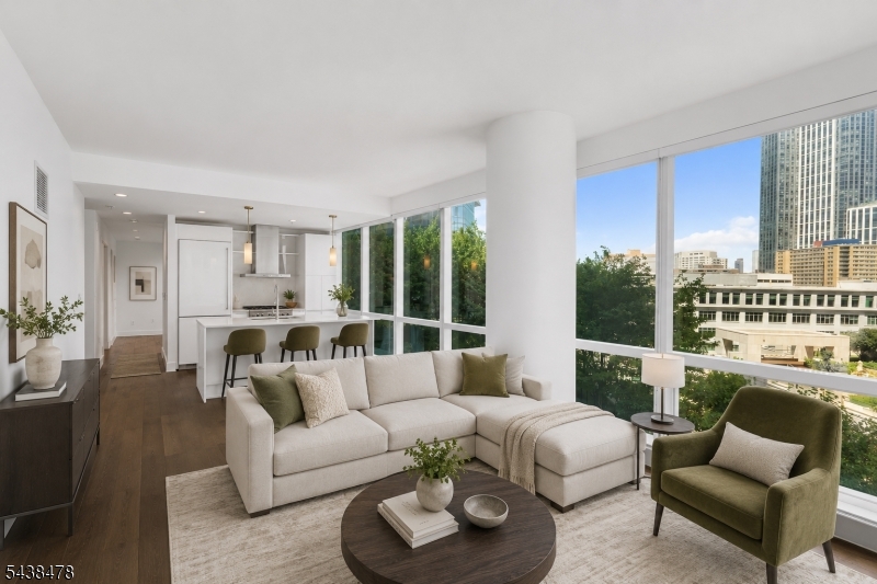 Welcome to 77 Hudson, one of Downtown Jersey City's premier luxury residences. This freshly painted 1-bedroom, 1-bathroom condo is located on the 12th floor and offers an exceptional combination of style, comfort, and convenience. Floor-to-ceiling windows in both the living room and bedroom fill the home with natural light while showcasing the vibrant city atmosphere below. The thoughtfully designed open-concept layout features a modern kitchen equipped with high-end appliances, a center island with seating, and ample space for both everyday living and entertaining. Additional conveniences include an in-unit washer and dryer and a reserved parking space in the building's enclosed garage. Residents of 77 Hudson enjoy access to an impressive collection of resort-style amenities, including a swimming pool, state-of-the-art fitness center, virtual golf simulator, game room, dog run, and playground. Ideally situated just minutes from Exchange Place, commuting is effortless with the nearby Exchange Place PATH Station offering a direct ride to the World Trade Center in approximately five minutes. Residents are also moments from Jersey City's acclaimed dining, shopping, waterfront promenades, and entertainment destinations. As an added value, the HOA fee includes water, gas, and trash/recycling services, making ownership even more convenient. Experience luxury living in the heart of Downtown Jersey City at 77 Hudson.