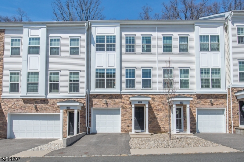 Located amid natural beauty- Community nestled within 52 acres of Natural Preserve. This spectacular townhome offers residents light, bright and OPEN living. Conveniently located in Rockaway Twp which provides easy access to major highways, NYC Direct Train Station & buses for an easy commute yet all the charm and benefit of small town living. Desirable Oakmont Model floor plan. Beautiful engineered hardwood floors throughout. Family room and full bath on the first floor. Head on to the main level which offers the open concept kitchen, dining and living room. Custom kitchen with white shaker style cabinets, granite countertops, center island and ss appliances flow to the large dining & living area. TONS of natural light with oversized windows. Custom made blinds. Access to the back deck/patio. Upstairs, a primary bedroom with full bath and walk-in closet. Two additional generous sized bedrooms & full bath with tub shower. Convenient laundry. Pristine condition. Less than 5 years young! The attached 1-car garage offers extra storage and a dedicated driveway. Thermal windows and doors. Smart Home Technology. HOA only $269 a month! Wonderful community with curbs and sidewalks. Playground too!