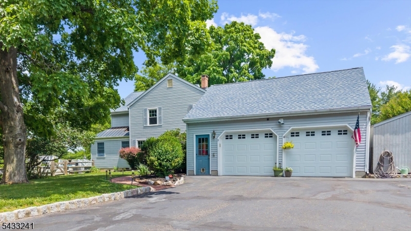 Situated at the end of a quiet cul-de-sac on over an acre of beautifully maintained property, this 4 bedroom, 3 full bath home offers the perfect blend of comfort, flexibility, and outdoor living. Sunlight pours through the home, highlighting oak hardwood floors and a thoughtfully designed floor plan that balances open gathering spaces with comfortable everyday living. The welcoming foyer leads to a formal dining room, spacious living room, and a well appointed kitchen featuring a breakfast bar, pantry, and dining area that flows seamlessly into the expansive family room. Cathedral ceilings and oversized windows create an airy feel throughout, while the adjacent three season sunroom provides the perfect place to relax and enjoy views of the property. A full bath with a walk in shower on the main level adds convenience and versatility. Upstairs, four generously sized bedrooms include a primary suite with a private bath featuring a soaking tub and separate shower, along with a large bonus room ideal for a home office, recreation room, or media space. Outside, the wraparound deck offers both covered and open seating areas, while a separate private courtyard creates a peaceful retreat. The backyard features an inviting pool enclosed by a charming split rail fence, adding to the property's picturesque setting. Just minutes from Flemington's shopping, and dining, this beautifully maintained home offers the space, comfort, and lifestyle you've been searching for.