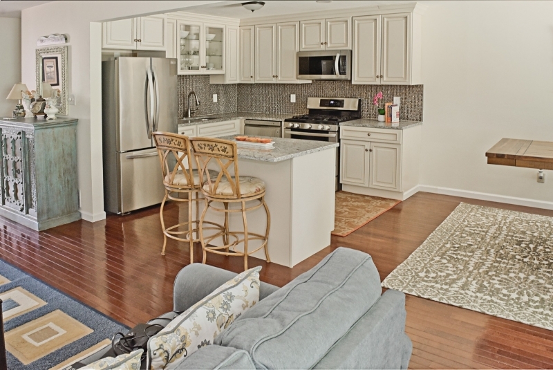 Spectacular Town-home unit is a true stand out! Spacious East facing town-home with open concept for today's lifestyle. This is a must-see home that is completely renovated. Like NEW HOME. PRICED FOR UPDATES. New/er Kitchen, Baths, Hardwood Floors, Basement, Recessed lights, Furnace & more. Rare to find town home like this w/ front big patio & private backyard. Living, Dining, Kitchen, 3 Bedrooms, 2.5 baths & full finished basement. Exquisite solid hardwood floors throughout. Kitchen features Custom Cabinetry, Stainless Steel Appliances, Granite Counter tops & Center Island. Elegant basement w/ laundry and utility room. Private Deck backs up to woods. Great Community living including Pool, Clubhouse & Tennis courts. Great schools. Close to shopping, dining, highways & Train station to NY. Home warranty.