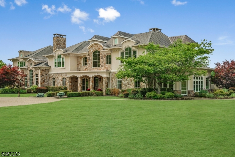 Welcome to The Princeton Preserve, a secluded sanctuary set on nearly 49 acres of pristine grounds. A mile-long private drive winds through untouched landscape before revealing a timeless estate designed for elevated living. Inside, gracious proportions and sunlit spaces unfold across all levels: bedrooms thoughtfully placed for privacy, a grand double-height foyer, a richly paneled office and a soaring two-story breakfast room that stuns with scale and natural light. The gourmet kitchen, complete with butler's pantry, opens to a series of elegant entertaining spaces, perfect for intimate gatherings or large celebrations. Designed with lifestyle in mind, the home flows effortlessly to the outdoors, where resort-level amenities await: an infinity-edge pool and spa, sports court, summer kitchen, expansive stone terraces and a private pond that reflects the changing seasons. The setting is tranquil, the views unending and the sense of escape complete. The lower level is a blank canvas ready to fulfill your vision, whether a wellness retreat, home theater, sports court or recording studio. A separate lower level with garage door offers the ideal setup for car collectors or hobbyists. With acreage suited perfectly for equestrian development, the possibilities are endless. At The Princeton Preserve, privacy, natural beauty and architectural scale converge to create a legacy estate without compromise.