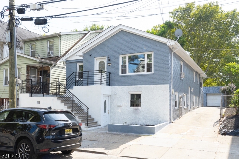 PRICE ADJUSTMENT!! 13-15 Eastern Pkwy is a spacious property located on a quiet block in the Greenville section of Jersey City. The 1st floor consists of  2 bedrooms, 1 bathroom, and an additional bonus unit with 1 bedroom and 1 bath. The 2nd floor offers 3 spacious bedrooms and 1 bath. Second floor boasts a balcony attached to the kitchen, providing access to a pleasant backyard space. The property features a 3 car garage and a long drive-way. Conveniently situated just a few blocks away from the light-rail and Turnpike, residents have easy access to various bus lines.