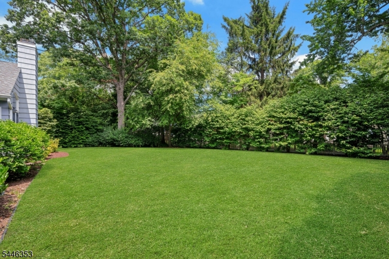 Welcome home to this inviting expanded Cape Cod, ideally situated in one of Chatham's premier neighborhoods. Step into the gracious living room where the sun spills in from the large bay window highlighting a classic wood burning fireplace, hardwood floors flow seamlessly into the formal dining room and an impressive family room with vaulted ceiling, palladium windows and fireplace -perfect for entertaining and everyday living! The spacious kitchen is open to the family room and offers abundant cabinetry, generous work space and a bright dining area surrounded by windows overlooking the lushly landscaped rear yard. Additionally, the first floor includes 2 bedrooms including a comfortable primary suite with a spacious bath featuring a double vanity, jetted tub and separate shower. A powder room completes this level. The second floor is host to 2 oversized bedrooms, a hall bath and additional storage. The lower level boasts a large recreation area perfect for additional leisure and fun and games! A bonus is the large utility/storage room with access to the garage. Ideally located in the heart of Chatham, just moments to downtown, train and top-rated schools, 28 Oak Drive offers endless possibilities on a premier street. A wonderful opportunity to create your dream home in an exceptional location!
