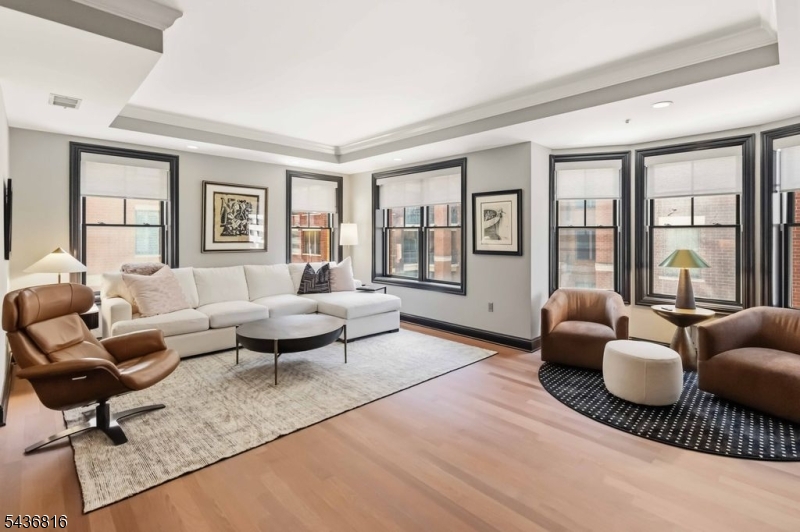 This elegant condominium offers the convenience of modern in-town living with easy access to everything you need. With 1300 sq. ft. of fabulous living space and wonderful amenities, this 2 bedroom, 2 bath home has rich Brazilian (just redone) cherry hardwood floors, 9 foot ceilings, and a freshly custom painted interior.  With a convenient 3rd floor location, this spacious end unit offers an open floor plan, custom gourmet kitchen with granite countertops and top-of-the-line appliances, and marble bathrooms. Enjoy your private balcony to unwind and relax or entertain friends.  Elevated amenities include full concierge service 365 days a year (7am to 11pm), private gym, and a beautiful club room with flatscreen tv, billiard table and a full catering kitchen perfect for effortless parties. Includes two deeded parking spaces (120 & 121) in private heated parking garage with direct entry into building (NO STAIRS).