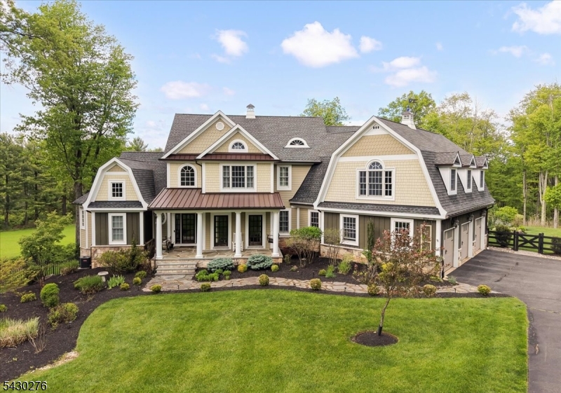 This nearly 7-acre retreat blends architectural warmth with modern functionality, enhanced by recent designer updates from Dan Ruhland. Located in the highly acclaimed Tewksbury Township School District, the property also benefits from a farm tax assessment. The home offers 4 bedrooms, 4 full baths, 1 half bath, with potential for an additional bedroom. The first-floor primary suite features sweeping views of the hayfield and surrounding forest, custom built-in closet and a spa-like bath with a jetted tub. A solid mahogany front door opens to a dramatic two-story foyer with reclaimed barn beams, leading into an expansive great room with cathedral coffered ceilings and rich chocolate-stained hardwood floors throughout. A striking blue soapstone fireplace, framed by white oak detailing that extends to the ceiling, while a 60-inch Albany three-tier chandelier adds scale and sophistication.The chef?s kitchen includes a DCS commercial-grade 6-burner range, dual ovens, pot filler, beverage refrigerator, glass-door refrigerator, carved enamel farmhouse sink, glazed white cabinetry, white-and-gray marbled granite countertops, and an oversized 9-foot island. Additional highlights include a dedicated first-floor office and finished walk-out basement with 11-foot ceilings, full bath and flexible living space. Outside, the fenced backyard offers a resort-style setting with a heated saltwater pool and spa, fire pit, and landscape featuring lavender, hydrangeas, and native flowers
