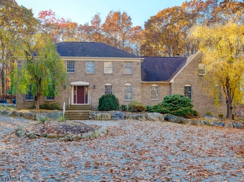 EXPECT TO BE IMPRESSED BY THIS RENOVATED BRICK FRONT COLONIAL NESTLED ON 2.78 ACRES. THIS GEM FEATURES BEAUTIFUL FINISHINGS, PRIVACY AND 4,000 SQ FT (PER TAX RECORDS) PLUS EXCEPTIONAL LIVING SPACE IN THE BEAUTIFUL, NEWLY FINISHED BASEMENT COMPLETE WITH FULL BATH, REC ROOMS & 2 OTHER ROOMS THAT CAN BE USED FOR ANYTHING YOU WISH. THE BASEMENT IS WALKOUT THROUGH THE GARAGE. YOU ARE WELCOMED BY A VERY LARGE FOYER AND MARVEL OVER THE ITALIAN PORCELAIN TILE FLOORING.  GORGEOUS, RENOVATED KITCHEN WITH QUARTZ COUNTERTOPS, CENTER ISLAND & STAINLESS STEEL APPLIANCES.  ENJOY THE SPACIOUS SUNROOM OFF THE KITCHEN WHICH LEADS TO THE ENTERTAINING-SIZED TREX DECK AND IN-GROUND, CONCRETE POOL. THE LIVING, DINING & GREAT ROOMS ARE ALL VERY LARGE AND HAVE WOOD FLOORING. THE SECOND FLOOR FEATURES 4 VERY SPACIOUS BEDROOMS, AS WELL AS A SEPARATE STAIR CASE THAT LEADS TO HUGE BONUS ROOM - NO CLOSET HERE BUT CAN BE USED AS 5TH BEDROOM, PLAYROOM, HOME OFFICE, GUEST ROOM, ETC. BEAUTIFUL BATHROOMS INCLUDING THE FIRST FLOOR FULL BATH. THE PRIMARY BEDROOM EN SUITE FEATURES A LARGE WALK-IN CLOSET AND EXQUISITE BATH WITH STALL SHOWER AND TUB. GLEAMING WOOD FLOORS THROUGHOUT THE 1ST FLOOR; CARPETING ON THE 2ND LEVEL. CONVENIENT TO ROUTES 80, 46 & 10.  SUPER CLOSE TO NYC TRAIN+BUSES+SHOPPING