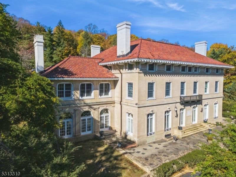 Introducing a rare opportunity to own a piece of Montclair history - a 1913 Renaissance Revival estate located in the highly sought-after Estate Section. The property includes 3 subdivided parcels, totally approximately 1.5 acres and boasts multiple terraces, a built-in pool, a sport court, and an integrated 2-car garage. This grand residence, offered as-is and awaiting your creative touch, boasts breathtaking original details and unparalleled character. Step into a spectacular foyer that sets an elegant tone with soaring ceilings and a majestic split staircase. The first floor showcases grand-sized rooms designed for both entertaining and relaxation. A formal library with built-in bookcases invites quiet moments, while the banquet-sized dining room captivates with its exquisite wood paneling, pocket doors, and intricate decorative ceiling. The expansive living room flows seamlessly into a charming solarium, highlighted by a classic black-and-white tiled floor and an impressive eight sets of French doors that flood the space with natural light. The upper floors offer a rare layout with 10 spacious bedrooms, nearly all with en suite bathrooms. The partially finished basement adds even more unique spaces, including a tea room and billiards area. Improvements include new heating system (2019), hot water heater, and upated windows. Don't miss this chance to reimagine and restore a true architectural masterpiece in Montclair.