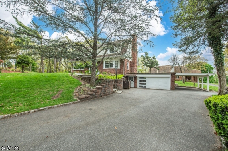 This is it!! Looking for a home that feels like a getaway everyday? Look no further! This home sits on 1.768 acres of park like setting in one would say is the quietest location in town! As you step up the stone stairs to enter the main door you are greeted with open foyer to your large living room with wood plank floors and a HUGE fireplace with lots of oversized windows that bring in TONS of natural light that you will love! Walk down the hallway to your sunroom with floor to ceiling windows, another gorgeous fireplace, a half bath off this room and opens to a paver patio to read your favorite book or enjoy a beverage of your choice. Step into your kitchen with center island, double panty closets and a separate eating area that opens to your newer extra large trex deck that looks out to your gorgeous yard! Step upstairs to wood plank floors that are one of kind and a must see.  Three LARGE bedrooms including primary bedroom with multiple closets & full bath with soaking tub. Walk-up attic area is partially finished can be home office, study area etc etc. Finished walkout basement with another fireplace, wet bar, full bath and summer kitchen. Solar Panels are paid off and included in sale. Subdivision possible was started years ago. More to come on this once in a lifetime opportunity in town.