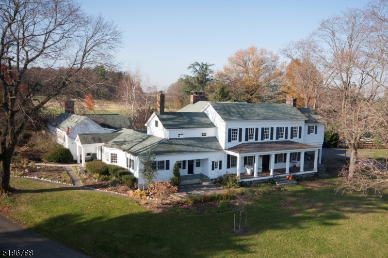 $54,000/yr REVENUE GENERATING property via rental and solar power income. A long driveway leads to this picturesque setting that includes spacious 4 bed, 4.5 bath Colonial offering a wide-open floor plan on 61.34 acres, a heated in-ground pool private oasis, 2 apartment guest house, bank barn with green house, tack rm, 5 stalls, plenty of space for equipment or country toys , 3 paddocks, 3 run-ins. First floor: cook's delight eat-in kitchen, bay window breakfast room, granite countertops, built-in Sub-Zero refrigerator, 5 burner gas cooktop with downdraft, Thermador dishwasher, Samsung convection wall oven, built-in microwave/convection oven, multi-generational or guest en-suite with entry, living room and large bedroom, living and family rooms, dining room, home office, billiard/rec room, powder room, sitting room with wet bar, hand painted backboard. Second floor: 2 additional en-suites. Main en-suite offers a 5-star resort bath, jetted tub, oversized arched tile & glass shower, commode room with bidet, 2 walk-in closets with custom cabinets. En-suite 3 offers full bath dressing room with built-in dresser and clothing racks, window seat, bedroom 4, laundry room, gorgeous main bath, linen closets. 5 fireplaces, 5 car garage, workshop, car ports, new garage and home roofs, turn key preserved farmland, 10-acre crave out allows for additional buildings and/or an additional residence, stocked fish pond, full property solar power, security system. Welcome home!