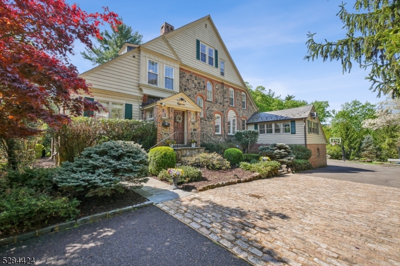 This magnificent mint condition south facing home has been renovated to perfection w/ stunning new baths, spectacular updated kitchen, & is the ideal blend of timeless elegance & modern luxury nestled in the most coveted neighborhood in Short Hills, walking distance to highly ranked Glenwood Elementary School (0.5 miles), the Short Hills Train Station (0.5 miles) & Arboretum (0.4 miles). 10' ceilings, formal dining room FP, sunlit living room w/ remote controlled Gas FP, 1st level office that opens to wrap-around stone patio &stunning gourmet eat-in kitchen. Gourmet eat-in kitchen has top of the line appliances, center island, marble countertops, custom cabinetry & brick wood-burning FP. Family room is spacious & bright w/ skylights & custom built ins. 2nd level has luxurious Primary Bedroom Suite w/ remote controlled Gas FP & new spa-like Primary Bath w/ floor to ceiling Quartzite tile, Quartzite mosaic flooring, shower, soaking tub, custom vanity & quartz countertop, & new WIC w/ custom built-ins. 2 more en suite bedrooms & laundry room complete the 2nd level. 3rd level has 2 more bedrooms & new full bath. Newly renovated lower level rec room, exercise room & storage. All major systems are new or newer: electric, plumbing & all new thermal windows. Whole house generator. The backyard is immense on 1.09 acres w/ plenty of room for a pool, mature evergreen trees providing great privacy, a wraparound patio & lower Bluestone patio, as well as a playground & trampoline.