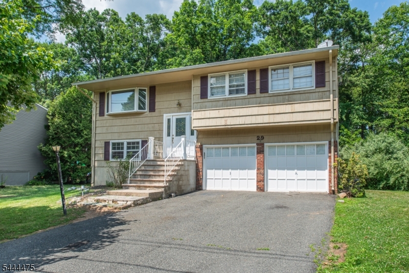 Welcome to this beautifully maintained bi-level home, ideally situated in a highly desirable location backing to private woods with a peaceful stream, offering the perfect blend of privacy and natural beauty. Enjoy outdoor living on the spacious deck and patio.Inside, the well kept kitchen features plenty of storage, and a functional layout, while hardwood floors add warmth and character throughout the main living areas. With four generously sized bedrooms, there's plenty of room!The level backyard provides plenty of space to enjoy the tranquil setting. A rare bonus, the attached two-car garage is both heated and air-conditioned, making it perfect for year-round use, hobbies, or additional workspace.Conveniently located just minutes from shopping, dining, and major commuter routes including Routes 46, 206, 80, and 10, this home offers the perfect combination of comfort, convenience, and a picturesque setting. Don't miss this exceptional opportunity!