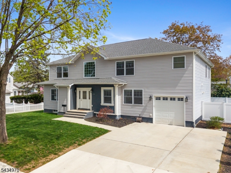 This is the modern comfort you have been waiting for. This spacious 6 bedroom, 3 full bath Colonial was expanded and completely reconfigured in 2023, offering approximately 3,500 square feet of living space. The main level features a two story foyer leading to a formal living room, separate dining room, and a spacious family room open to the kitchen with center island, granite countertops, and a backyard facing sink. A first floor bedroom, full bath, and laundry area provide an ideal setup for guests, extended living, or a home office. The second level includes five spacious bedrooms, including a large primary suite with private bath, dual sinks, jacuzzi tub, and separate shower. The finished basement adds additional space for fitness, recreation, or storage. First floor access to the one car garage and a three car wide driveway add everyday ease. Conveniently located near schools, shopping, major highways, and nearby train access, offering easy commuting locally and to NYC.