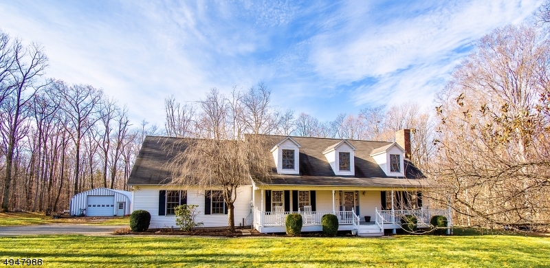 This clean and classic 4 bed 3 full bath cape is completely renovated with warm modern finishes and many extras all on a private 5+ acres. Pride of ownership and attention to details shine through in this home.  Wood grain flooring and an open floor plan tie together the first floor living area.  The first floor master is spacious and features an ensuite bath.  Upstairs the two large bedrooms are connected  by a center loft area which also features another full bathroom.  A large attic room off the bedroom offers lots of storage and staircase access to the 2 car garage.  Underground electric lines, a large metal garage on concrete slab, and an outdoor woodburning furnace tied into the heat and hot water are just a few extras.