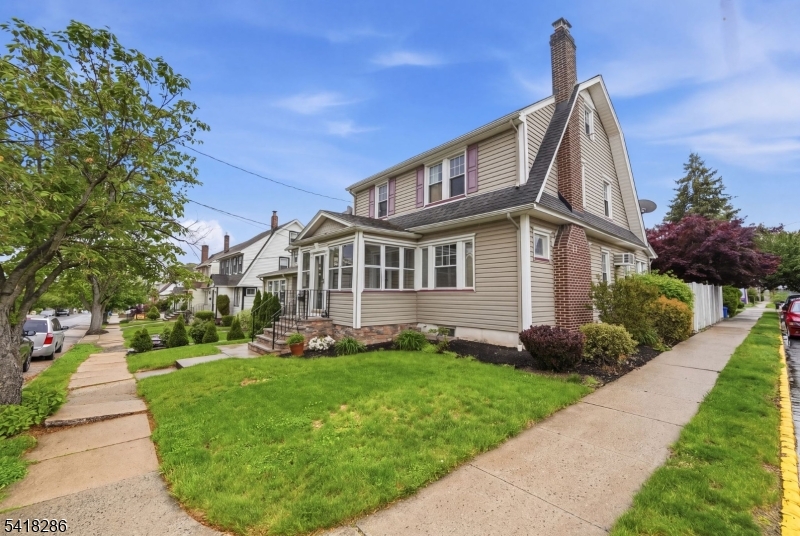 Terrific home in a terrific neighborhood! Features a stone front stoop and a welcoming, enclosed front porch with a ceiling fan. This colonial offers spacious, comfortable rooms with hardwood floors throughout. The eat-in kitchen boasts a tiled peninsula with included stools and storage. Enjoy the great-sized living room with a wood-burning fireplace, built-in bookcases, and stained glass. The formal dining room is ample and has a BI AC. The first floor includes a powder room and a mud room leading to the two-level deck, half trex, half wood. This home also has a first-floor den/office/sunroom. A heated, fourth bedroom with laminate flooring is located on the third level. Two car garage with a separate entrance door. There is a crawl space in the walk up attic with 3 window ac's included. There is a freezer and a fridge in the basement, that is included. The driveway/garage is on the corner of Forest. This home should check most of your boxes.