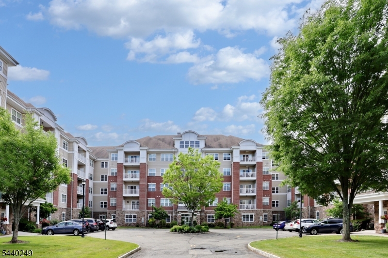 More than a home...it's a lifestyle! Two deeded underground parking spots, #87 and 33, and a 6x10 deeded storage unit next door, # 2C, are a few of the amenities of this 1768 SF Colfax unit in the Del Webb 55+ active adult community of Wanaque Reserve. Some other great things about this home is that it is next door to the 20,000 SF clubhouse...the indoor and outdoor pools, cafe, exercise room, and the more than 45 clubs and activities as well as the gatehouse which provides 24-hour security. The home features a living room with sliding doors, which open to the private balcony, dining room, den/home office with French doors, adding a touch of elegance, eat-in-kitchen with plenty of cabinets and pantry, laundry room off the kitchen, primary bedroom ensuite with tray ceiling, walk-in-closet and another closet, full bath with walk-in-shower, double vanity and private toilet room, 2nd bedroom and full bath. Some of the clubs and activities include the travel club (four or five trips as well as several casino trips per year), tennis, pickleball, canasta, mahjong, poker, ballet, art classes, etc.  Wanaque Reserve offers a luxurious lifestyle for its residents with a focus on modern amenities, security and a sense of community. The recent renovation adds a fresh and updated living environment.
