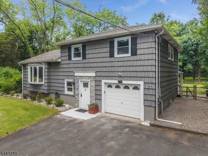 Move right into this beautifully renovated split-level on over 2.5 private acres! The expansive backyard stretches all the way to the next street, offering incredible space to roam, play, and entertain. Inside, an open floor plan flows seamlessly, anchored by a stunning kitchen with white shaker-style soft-close cabinets, a center island, breakfast bar, granite countertops, and stainless steel appliances. Gray stained hardwood floors run throughout the first and second levels, and recessed lighting adds a modern touch. Both bathrooms have been fully renovated. Major systems are all newer (2019), including the HVAC, roof and gutters, hot water heater, and windows/doors   true peace of mind for years to come. Step outside to a deck off the dining room and a covered patio overlooking the wooded, park-like lot   perfect for relaxing or hosting. The finished basement adds even more living space for a rec room, home office, or gym. Located close to schools, shopping, parks, and the library, with an easy 15-minute ride to the Somerville Train Station. A rare combination of privacy, space, and updates don't miss it!