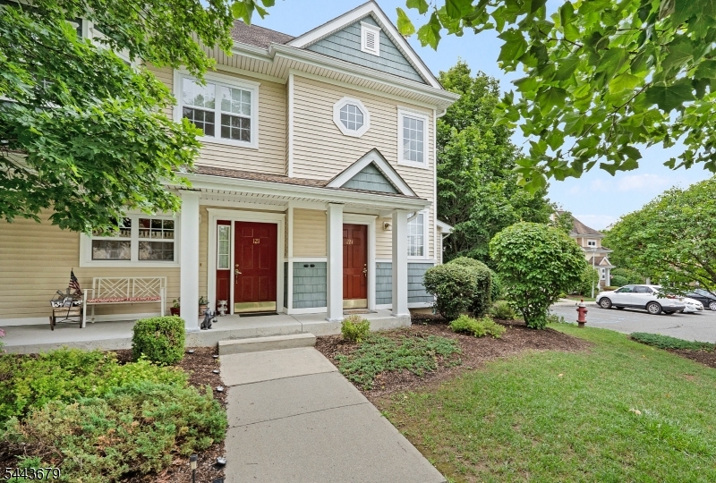 Welcome to 221 Old Farm Rd in the desirable Old Farm Village section of Panther Valley, private community in Allamuchy, NJ. This beautifully maintained 2-bedroom, 2-bath townhome offers exceptional with  peaceful wooded views and a move-in ready interior. Freshly painted throughout, the bright open floor plan features a spacious living room with a gas fireplace and a beautiful vinyl glass door leading to a private balcony, perfect for morning coffee or relaxing outdoors. Brand-new carpeting throughout the home complements the kitchen, which features new luxury vinyl plank flooring (2026), stainless steel appliances, including a refrigerator (June 2020), dishwasher (September 2022), stackable washer and dryer (February 2023), stove (November 2024), and water heater (November 2024). Custom closet organizers maximize storage throughout. The primary suite offers a large walk-in closet and an en suite bath with a tiled tub/shower. A spacious second bedroom and full bath provide flexibility for guests or a home office. Residents enjoy three pools, tennis, pickleball, basketball, volleyball, playgrounds, walking trails, and nearby Allamuchy Dog Park. Minutes from Route 80, Hackettstown shopping, restaurants, NJ Transit, Centenary Stage Company, and state parks.