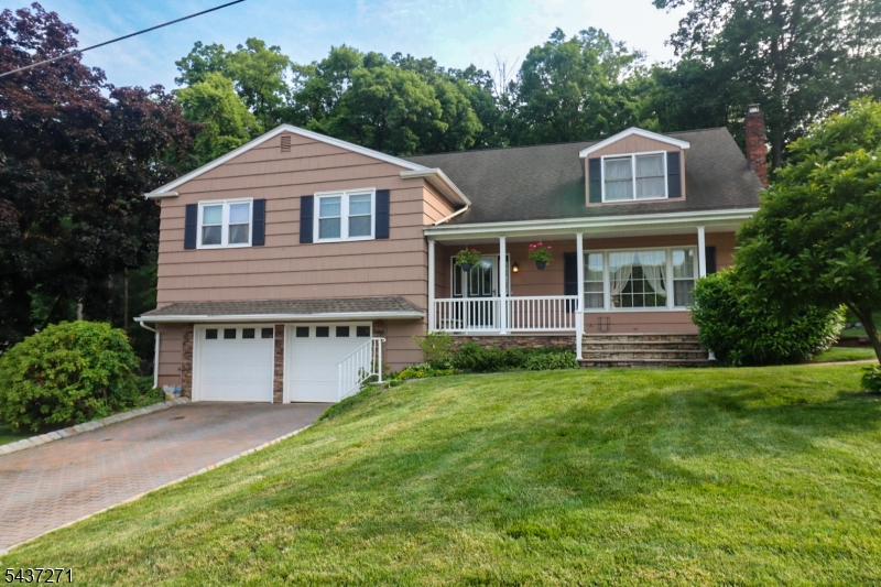 Exceptional oversized split-level home with two additions and four finished levels of living space! Updated kitchen (within the last 5 years) features granite countertops, soft-close cabinetry, glass display cabinets, built-in coffee bar, and Samsung black stainless appliances including French door refrigerator, double-oven range, and dishwasher. Kitchen opens to dining area and bright sunroom, creating a spacious, open floor plan. Large living room offers laminate flooring and a picture window for abundant natural light. Outdoor oasis includes a beautiful in-ground pool, multi-tiered deck, patio, two sheds, and paver driveway. home features two primary suites with private baths. Newer primary suite Boasts vaulted ceilings with skylights, Palladian window, private balcony overlooking pool, walk-in closet, bonus room accessed by private staircase (ideal office or sitting room), and luxury bath with soaking tub, walk-in shower, double vanity, and private water closet. Additional closet designed for future sauna. Ground-level family room showcases a stunning stone wall, wood-burning fireplace with stove insert, and accent lighting. Additional features include cedar shake siding, Timberline roof, two-car garage with 10-ft ceilings, extensive storage, and two garage door openers. A truly unique home offering exceptional space, flexibility, and indoor/outdoor living