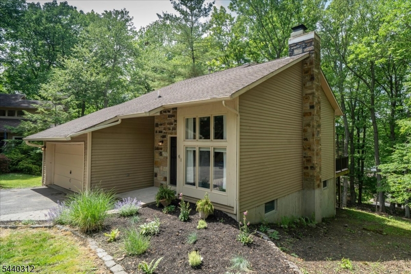 Beautifully updated 4 bedrm, 3 full bath contemporary nestled in highly sought after Panther Valley. This exceptional home offers an open concept flr plan, hardwd flrs and an abundant of natural light. The main level features living rm and dining rm w/vaulted ceiling, wood-burning fireplace, custom built-in cabinetry and shelving. The modern refreshed kitchen is equipped with oak cabinetry, granite countertops, stainless appliances, pantry and sliding doors leading to the expansive deck. First floor oversized primary suite offers a walk-in closet and beautifully updated en-suite bath featuring marble dbl vanity and custom walk-in shower /frameless glass doors. 2nd Flr offers 2 generously sized bedrms, each boasting walk-in closet, plus beautifully renovated full bath w/tub and shower. The ground level features 4th bedroom, stylish updated en-suite full bath w/walk-in shower, plus a large walk-in closet. There is also a large family rm w/sliders to private rear yard. There is a convenient laundry room and versatile bonus rm. Enjoy the expansive private deck overlooks peaceful wooded surroundings. This must have home also features newer furnace/AC, water heater, 2 car garage. Enjoy an array of amenities, privacy gate, 3 swimming pools, tennis courts, volley ball, playground and trails. Conveniently located near shopping, dining, Rt 80, offering easy access for commuters and NJ Transit Bus to NYC. Move right in and start enjoying everything this exceptional home and community.