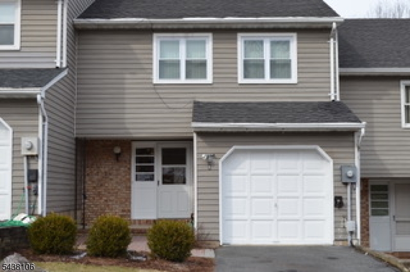 Spacious 3-bedroom, 2.5-bath townhome with a finished walkout basement and private level backyard in the highly desirable Powder Mill Village community! The main level features hardwood flooring, a wood-burning fireplace, and an open-concept layout that flows seamlessly to a large deck, perfect for entertaining and everyday living. The second floor offers three generously sized bedrooms and updated bathrooms. The renovated walkout basement features luxury vinyl plank flooring and provides flexible space for a recreation room, home office, gym, or media area. The home has been freshly painted and is move-in ready. Ideally located on a charming street, this home is just a short walk to the community clubhouse, pool, tennis courts, and playground. Enjoy the convenience of nearby restaurants, shops, convenience stores, salons, and other everyday amenities. Commuters will appreciate easy access to major highways, NYC train service, and bus transportation. Exceptional location, desirable community amenities, and a beautifully updated interior make this a must-see home!