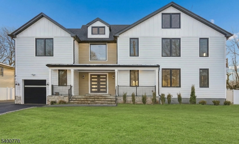 A striking statement of modern luxury, this extraordinary custom-built Colonial on existing foundation in Westfield showcases exceptional craftsmanship, refined architectural detail, and a thoughtfully designed open layout filled with natural light. Dramatic windows, custom millwork, and rich hardwood floors create a sophisticated yet inviting atmosphere throughout. The chef's kitchen serves as the heart of the home with quartz countertops, an expansive island, bespoke cabinetry, and top-tier appliances including a 6-burner stove and pot filler, flowing seamlessly into the family room with electric fireplace and access to the private backyard and patio. The first floor offers a private office, guest suite with full bath, formal living and dining rooms with built-in bar, powder room, and mudroom. The second level features a stunning primary suite with balcony, fireplace, custom walk-in closet, and spa-like bath, along with a princess suite, two additional bedrooms, two full baths, and laundry. A third-floor retreat and finished walk-out basement provide additional living space. Outfitted with tankless hot water and Cat 6 wiring, and ideally located near downtown, top-rated schools, and NYC transportation.